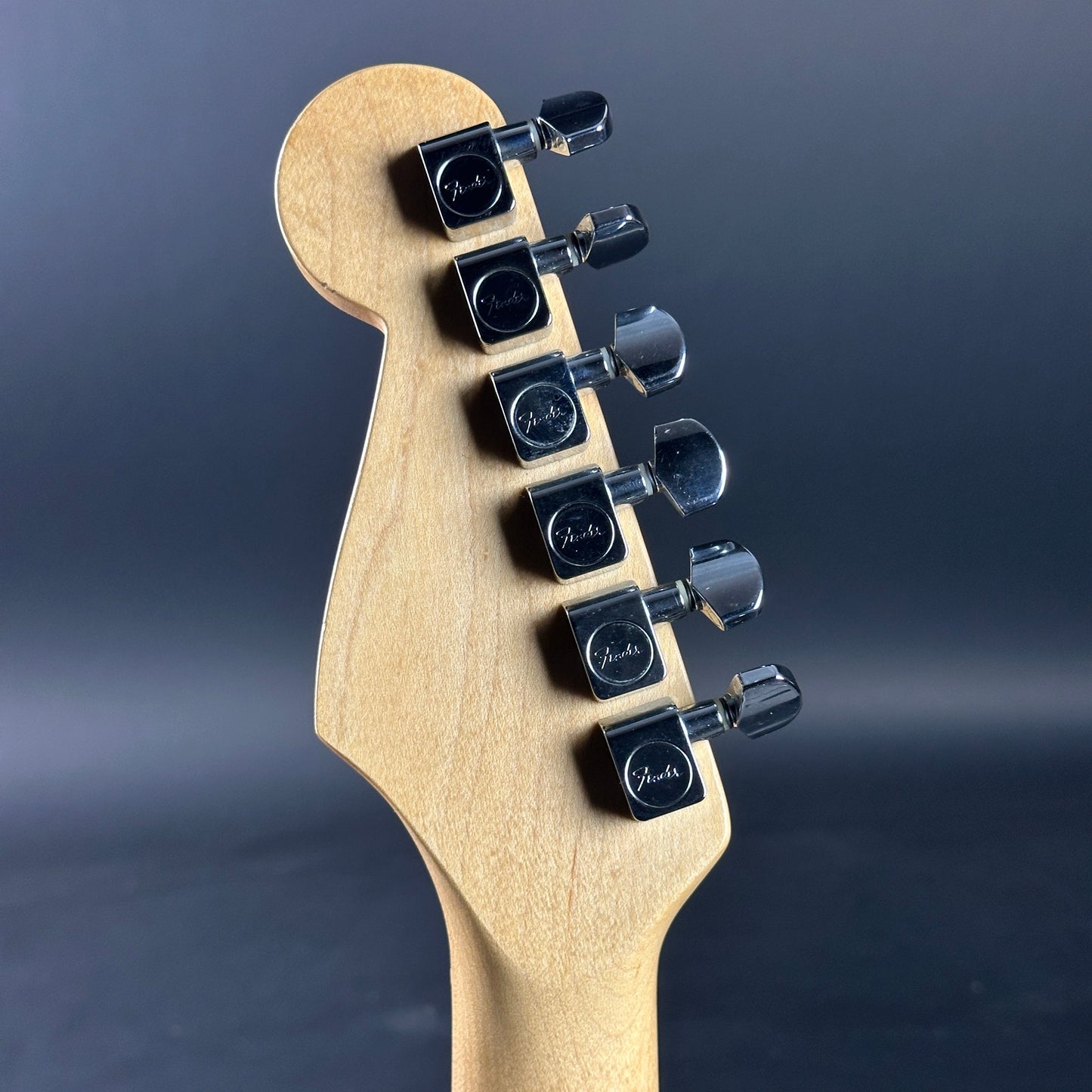 Back of headstock of Used Fender MIM Standard Strat Black.