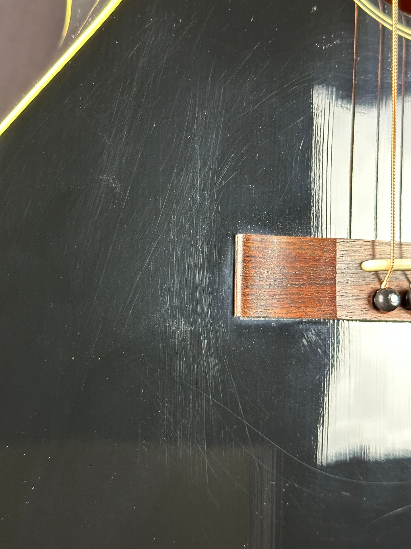 Scratches near bridge of Used 2023 Gibson L-00 Black.