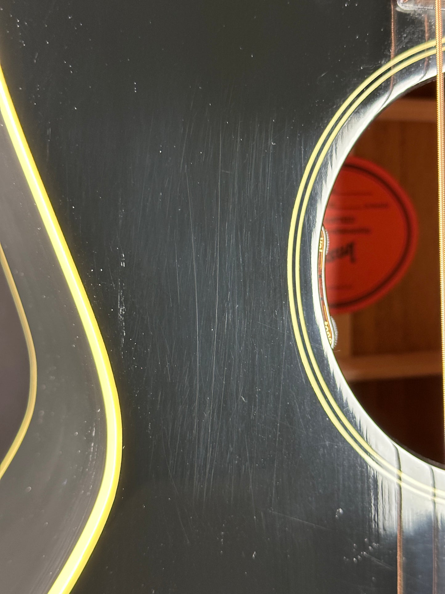 Scratches near soundhole of Used 2023 Gibson L-00 Black.