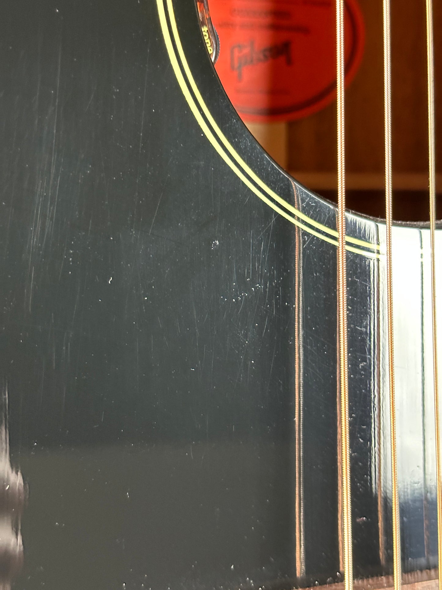 Scratches near soundhole of Used 2023 Gibson L-00 Black.