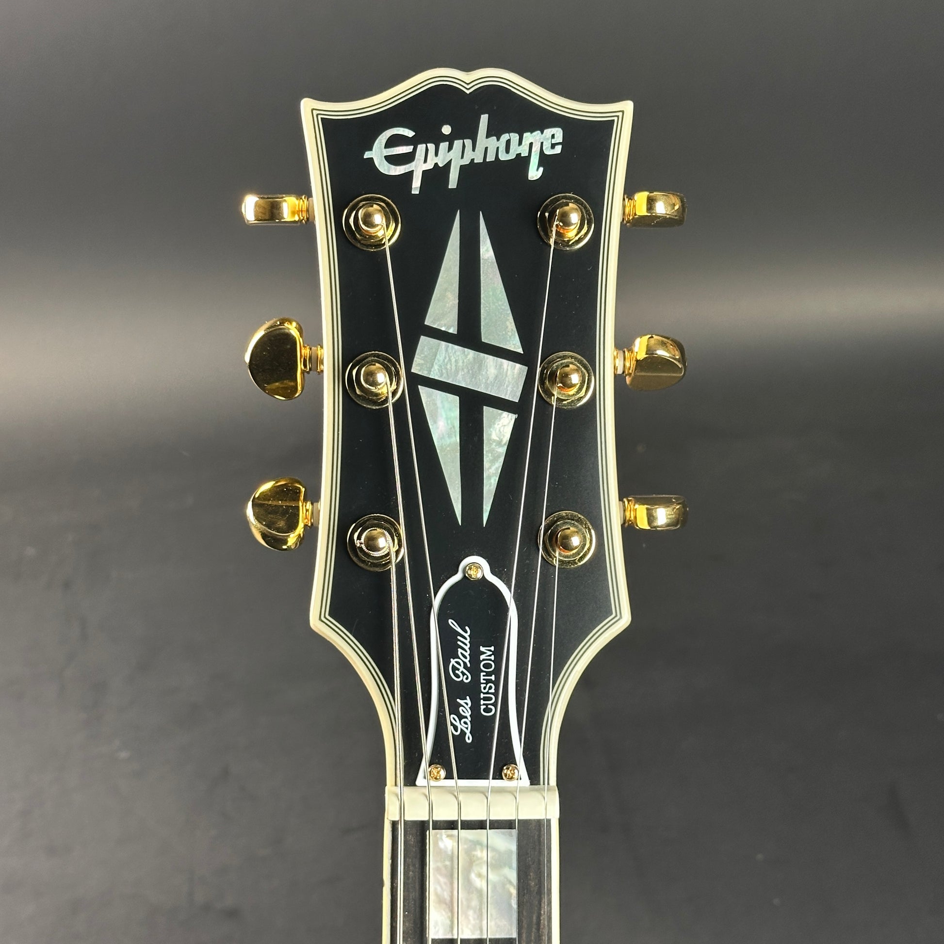 Headstock of Used Epiphone Inspired by Gibson 1963 Les Paul SG Custom Vibrola Classic White.