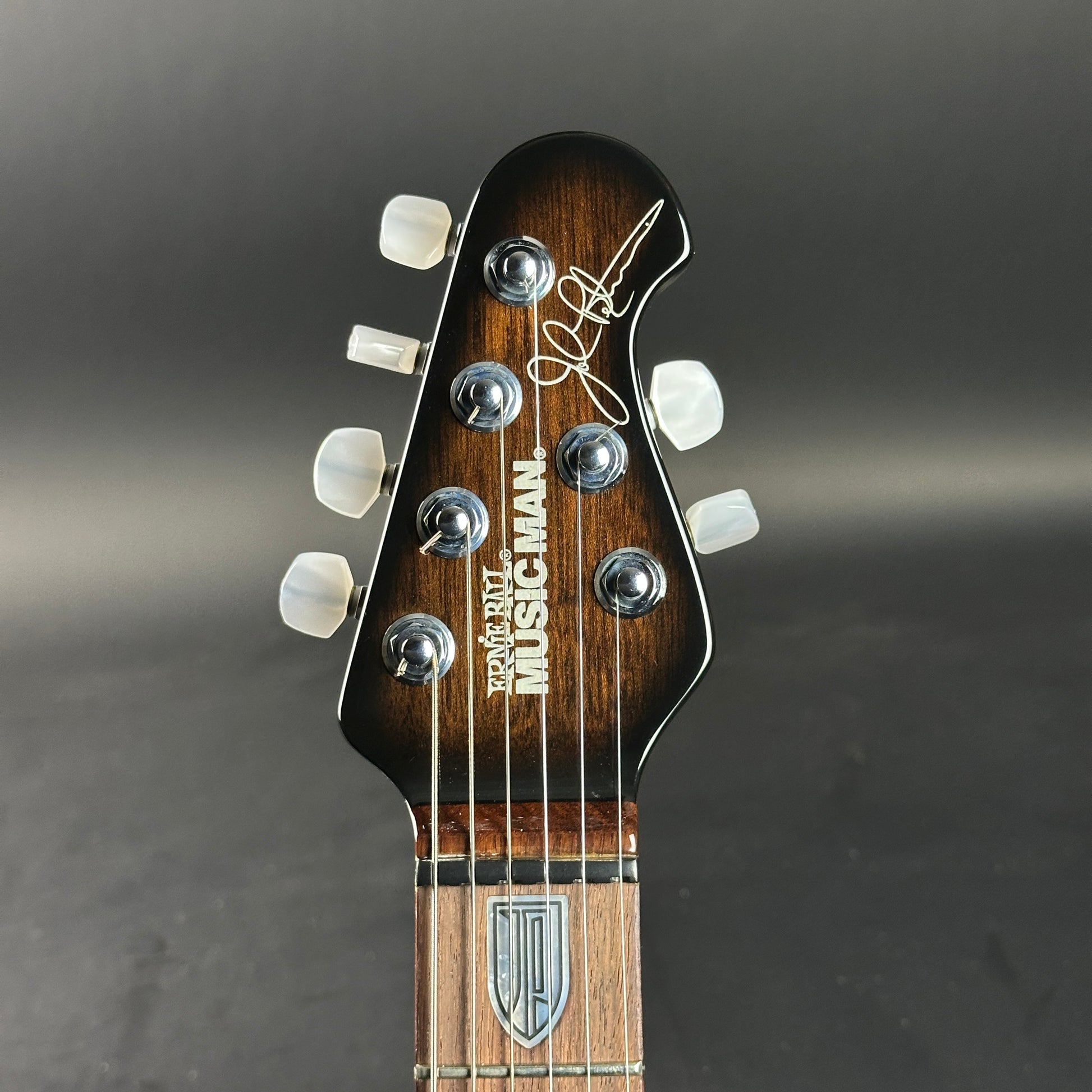 Headstock of Used 2007 Ernie Ball Family Reserve Petrucci Black Sunburst.