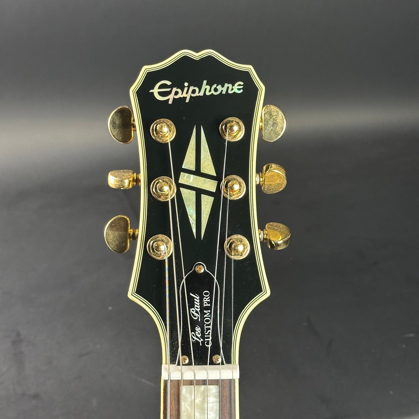 Headstock of Used Epiphone Les Paul Custom Pro White.