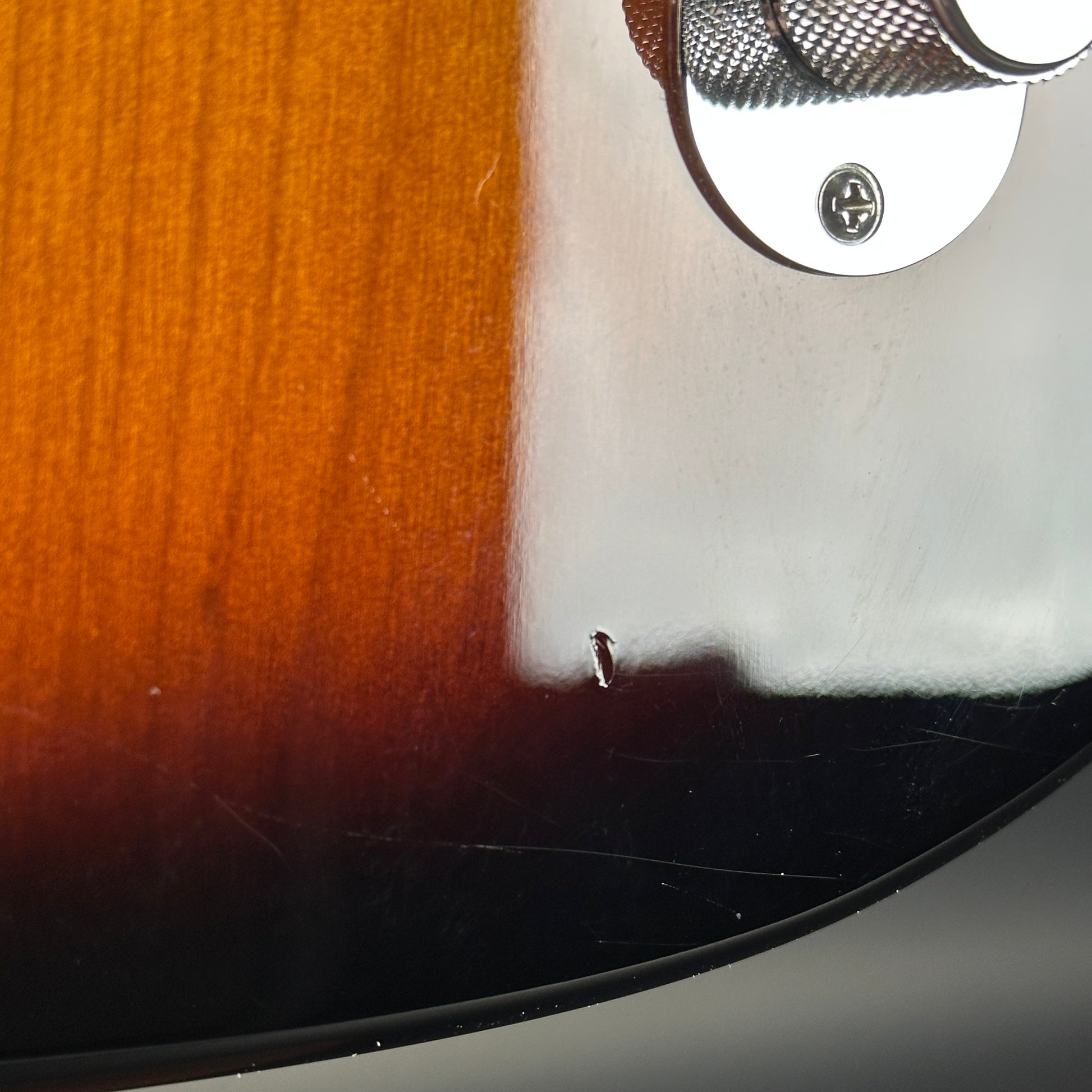 Ding near controls of Used 2014 Fender GC USA Pro Standard Telecaster HS 2-Color Sunburst.