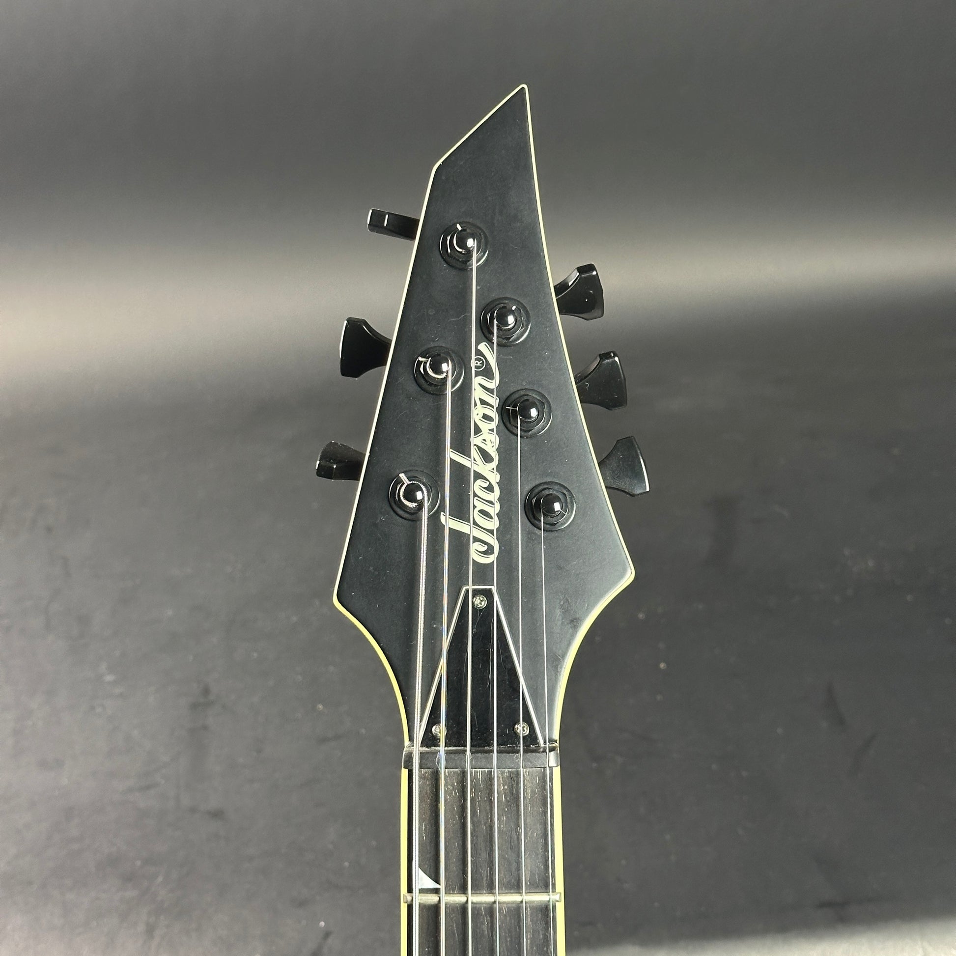 Headstock of Used Jackson SLSMG Flat Black.