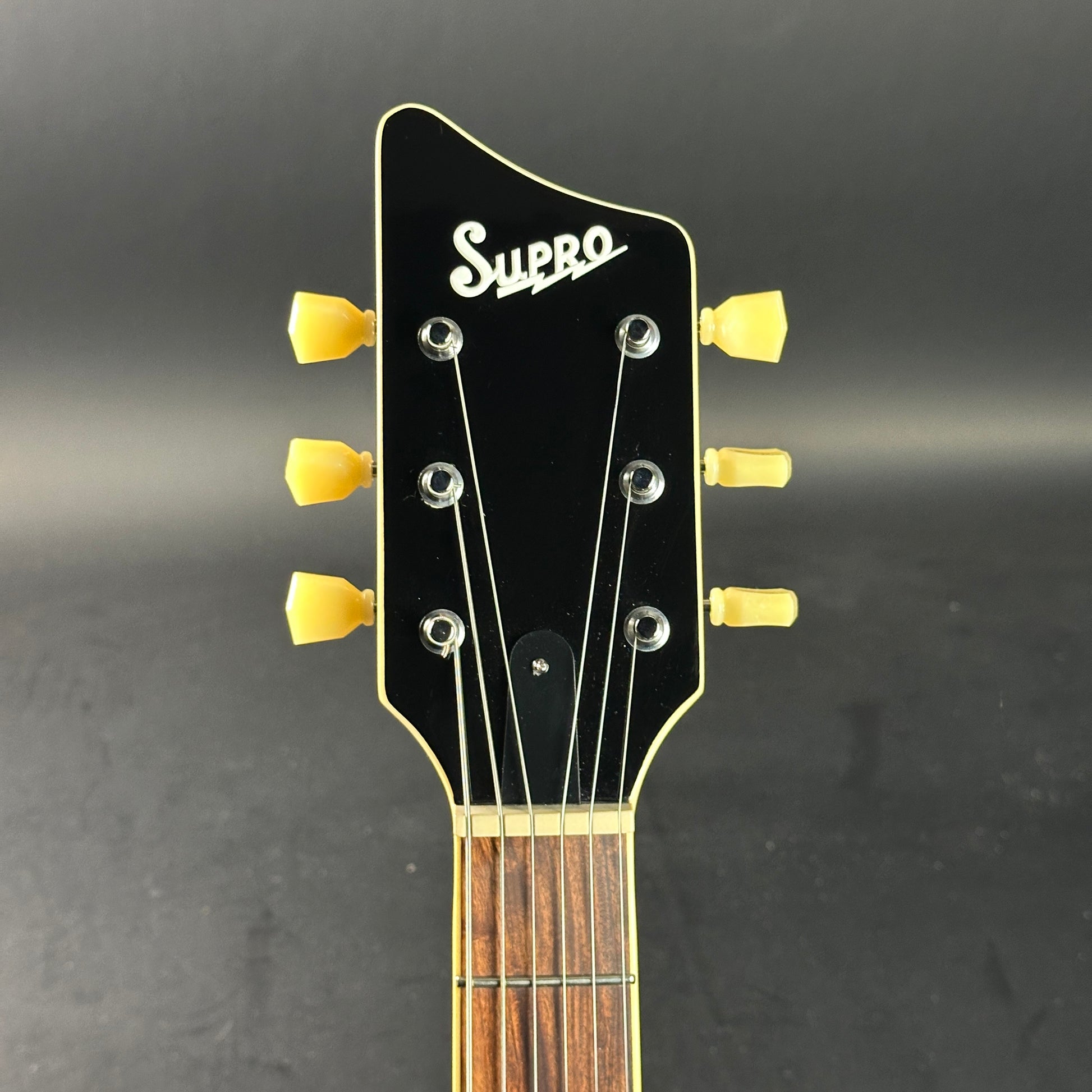 Headstock of Used Supro Conquistador Green.