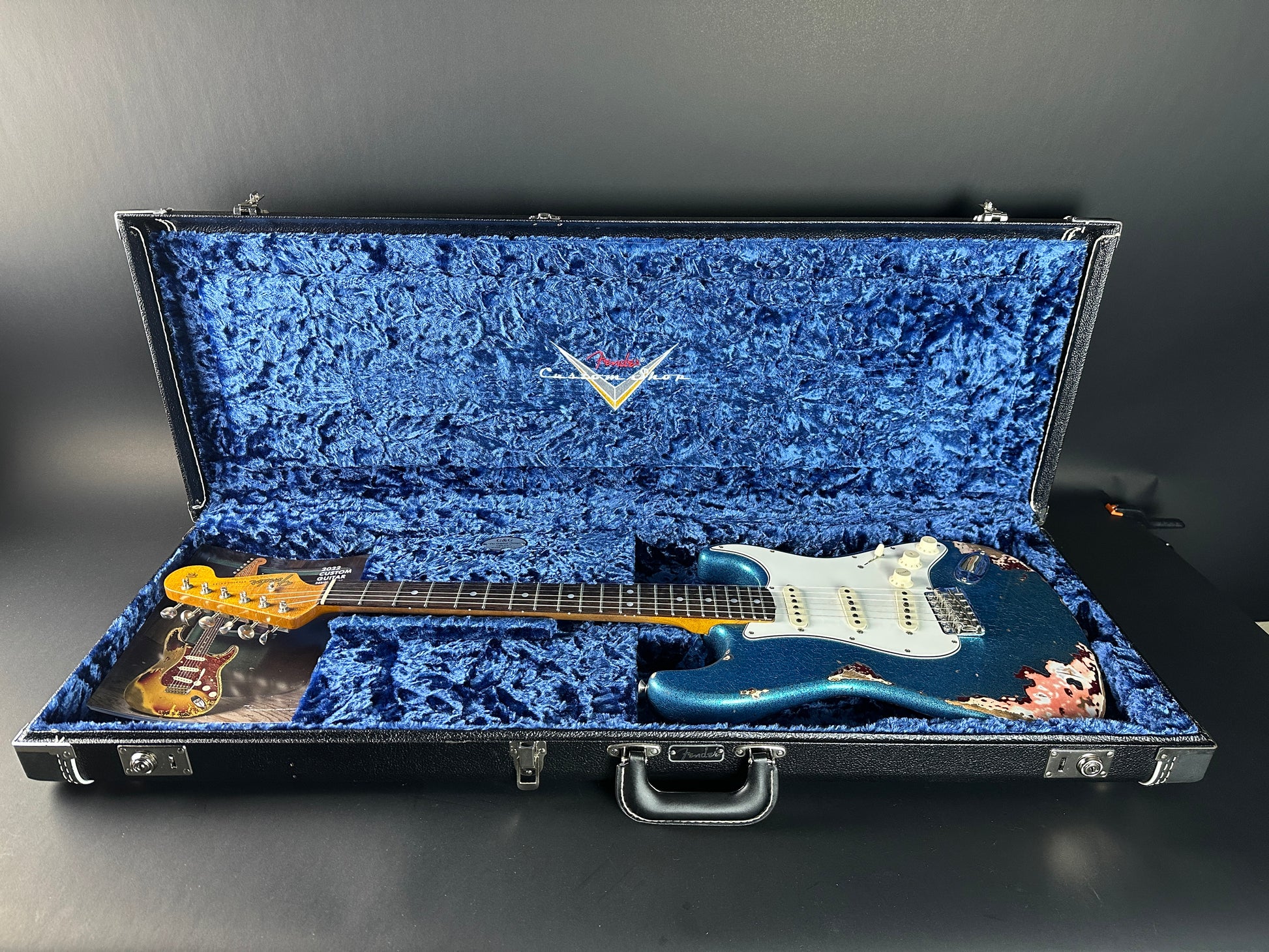 Used Fender Custom Shop GC Tex Strat Heavy Relic Blue Sparkle Over Candy Apple Red in case.