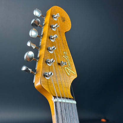 Front of headstock of Used Fender Custom Shop GC Tex Strat Heavy Relic Blue Sparkle Over Candy Apple Red.