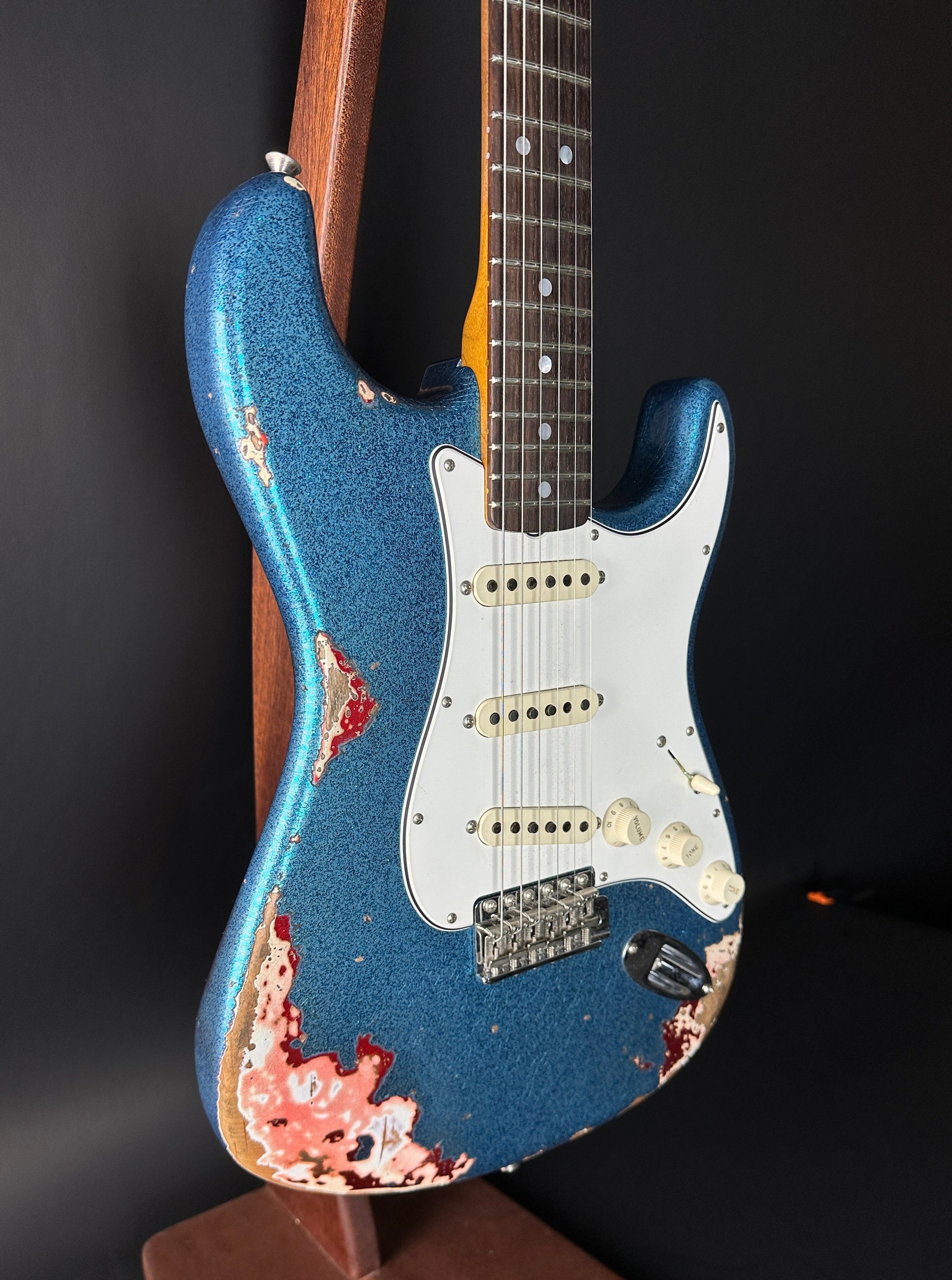 Front angle of Used Fender Custom Shop GC Tex Strat Heavy Relic Blue Sparkle Over Candy Apple Red.