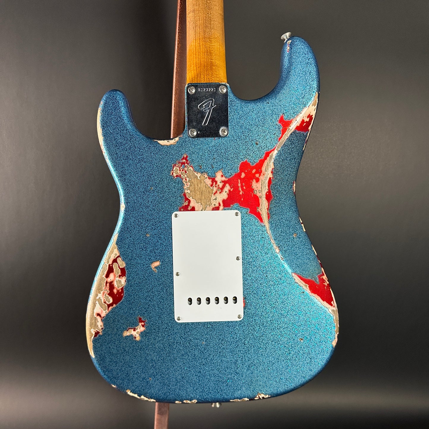 Back of Used Fender Custom Shop GC Tex Strat Heavy Relic Blue Sparkle Over Candy Apple Red.