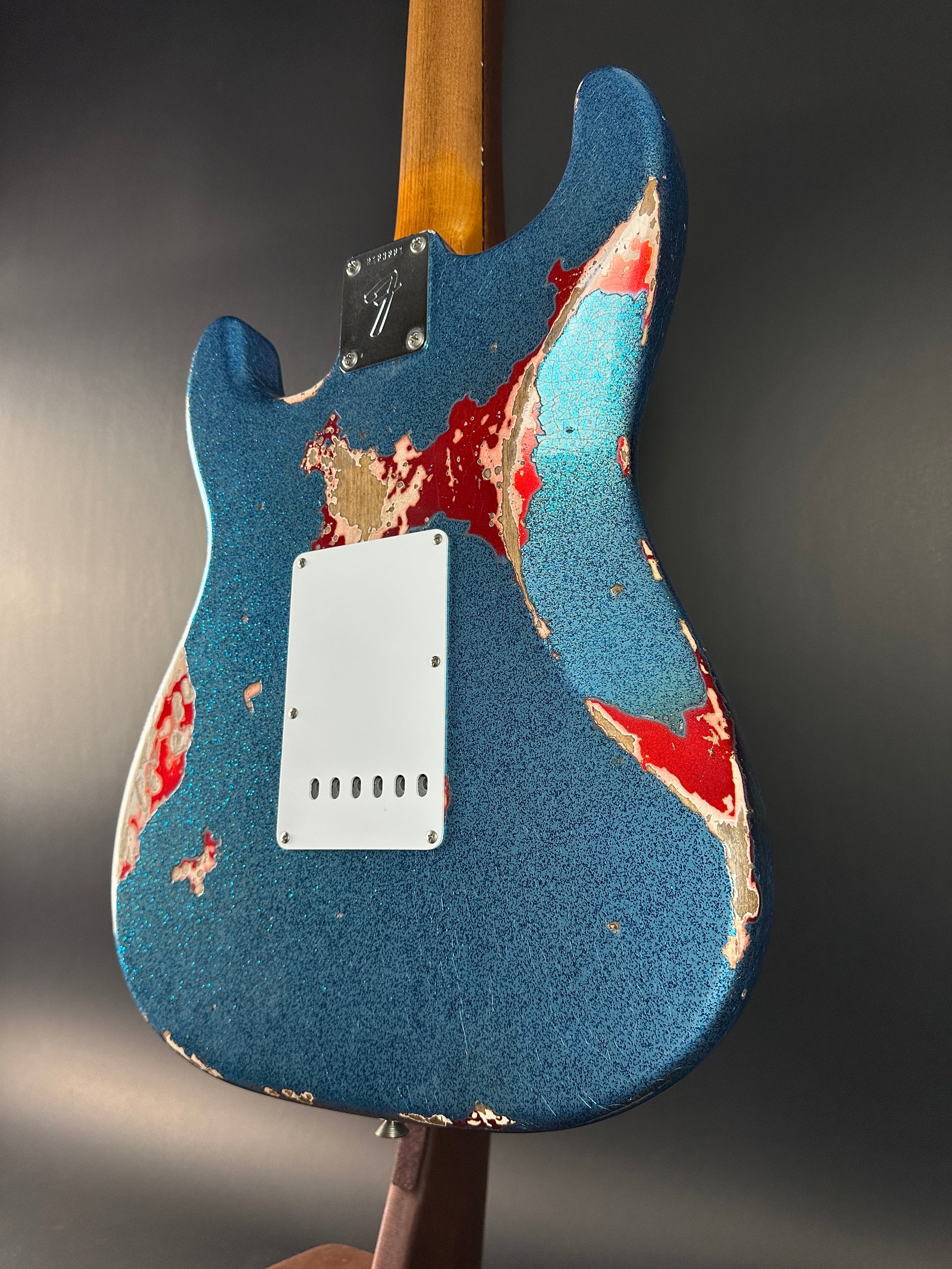 Back angle of Used Fender Custom Shop GC Tex Strat Heavy Relic Blue Sparkle Over Candy Apple Red.