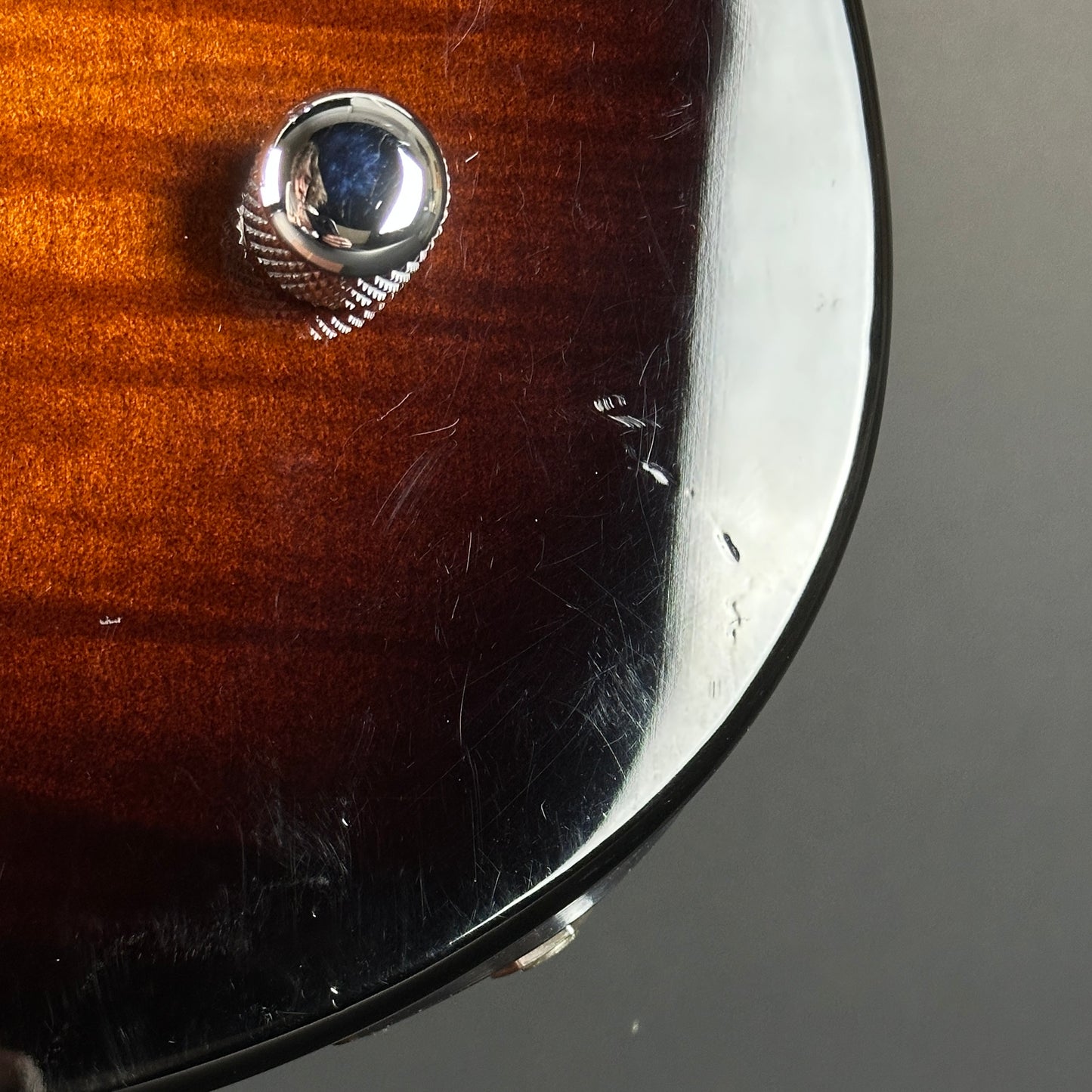 Scratches near controls of Used Yamaha Pacifica PAC212VFM Burst.