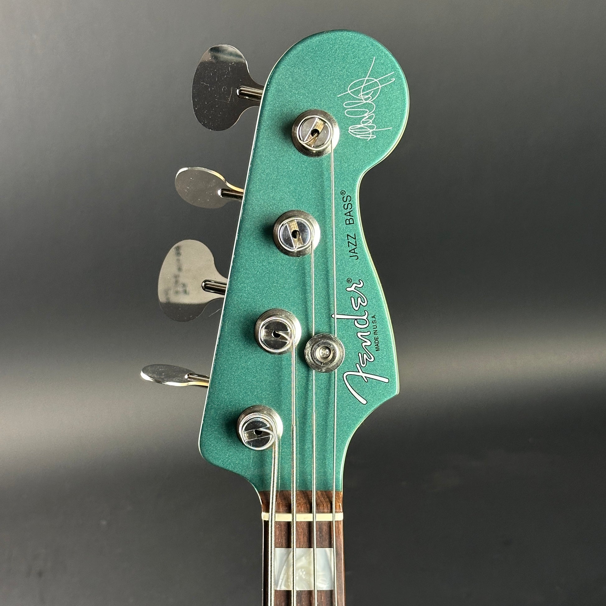 Headstock of Used Fender Adam Clayton Jazz Bass Green.