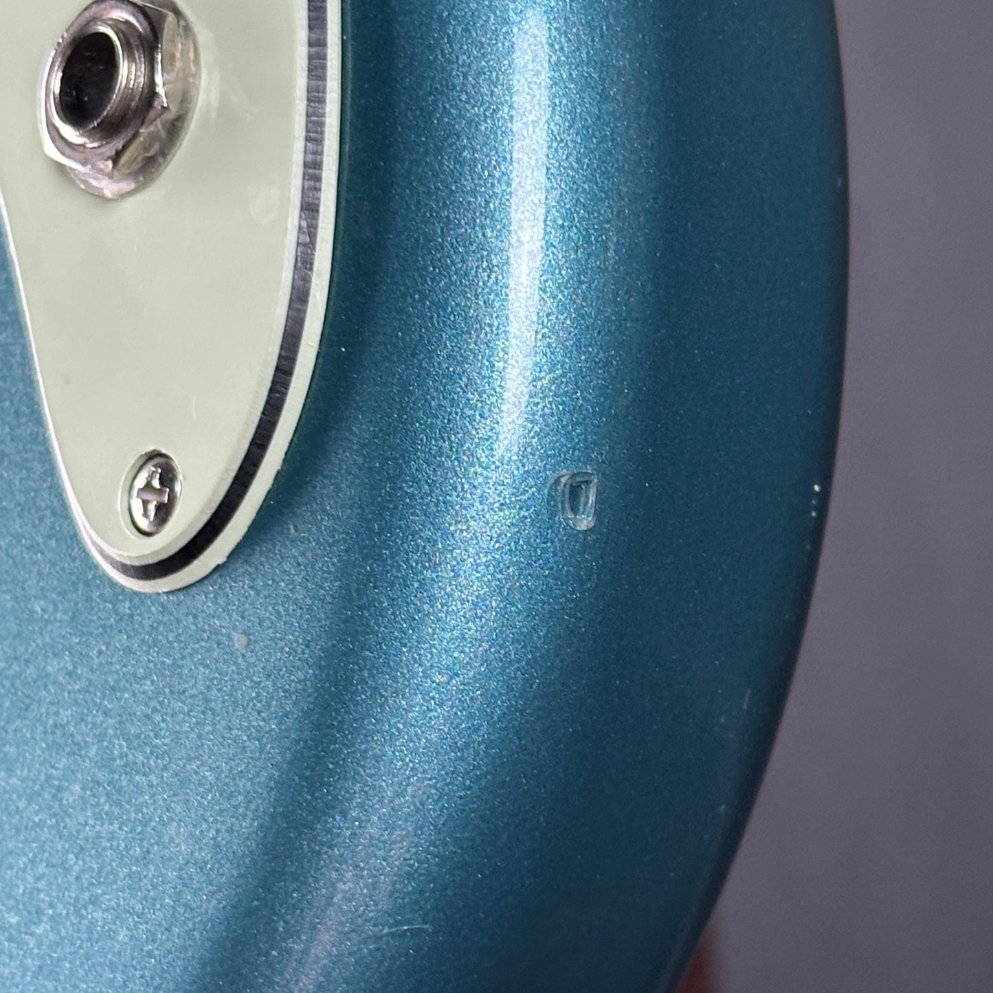 Dent near output jack of Used Fender Player Duo Sonic Tide Pool Blue.