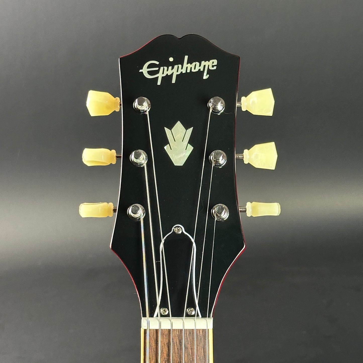 Headstock of Used Epiphone Dot Cherry ES-335.