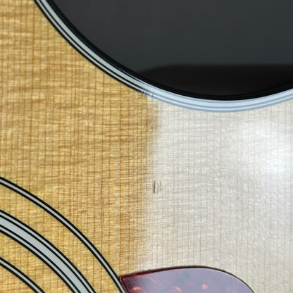 Ding near pickguard of Used 2012 Taylor 314ce.