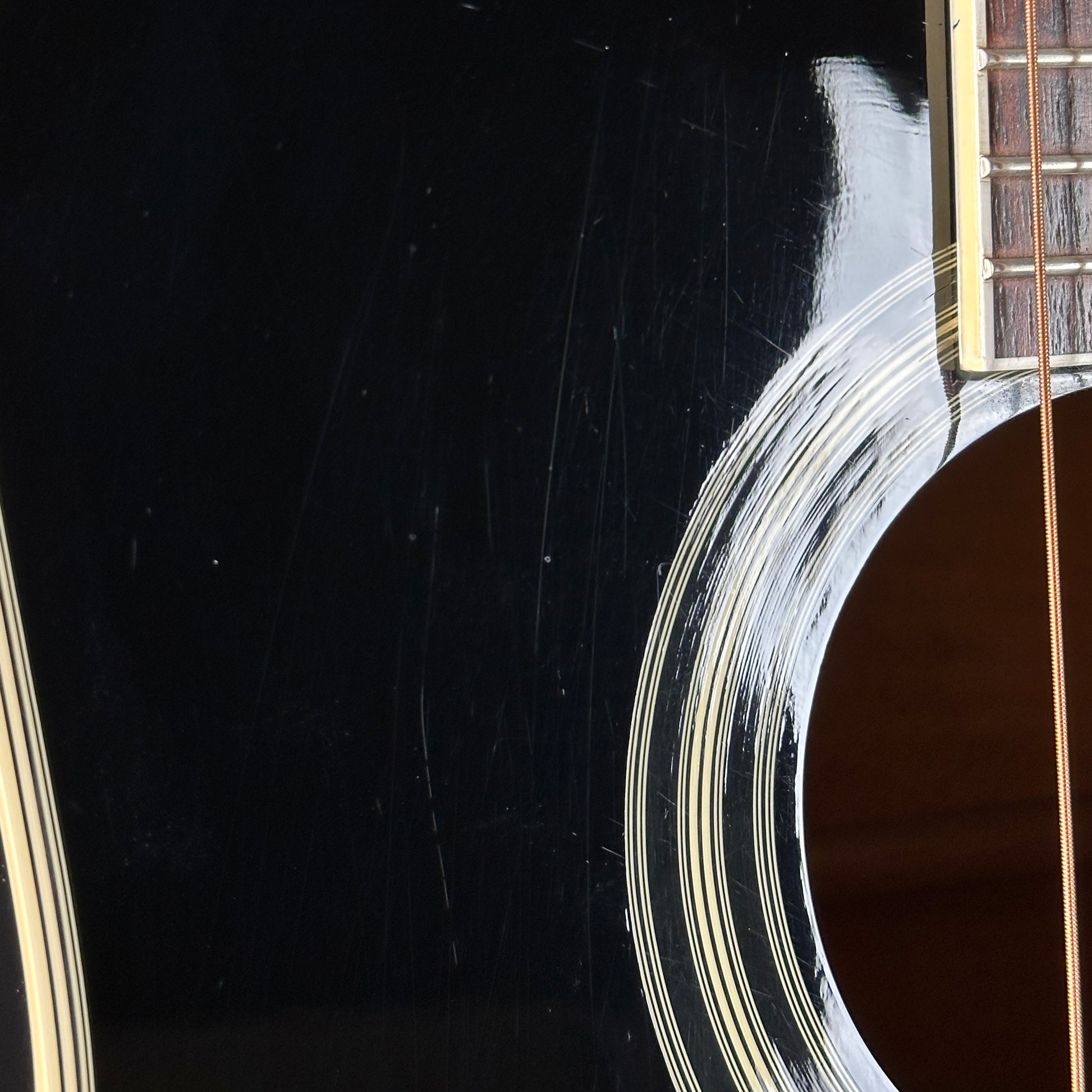 Scratches near soundhole of Used Takamine EF341c Black.