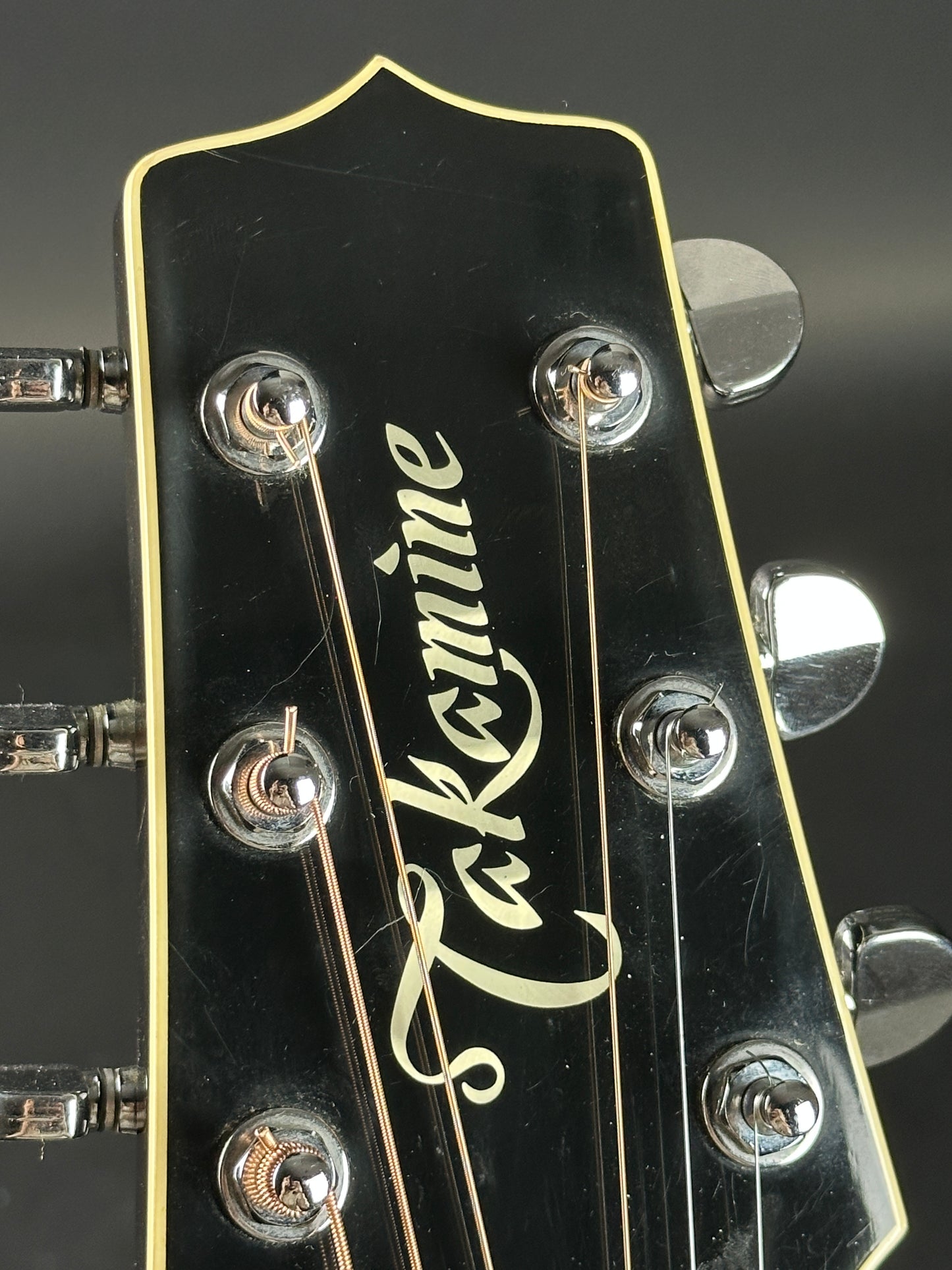 Scratches on headstock of Used Takamine EF341c Black.