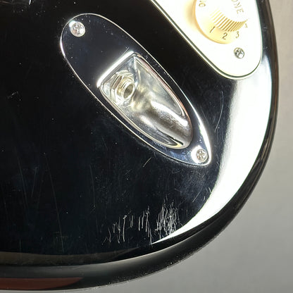 Scratches near output jack of Used 2013 Fender American Standard Strat Black.