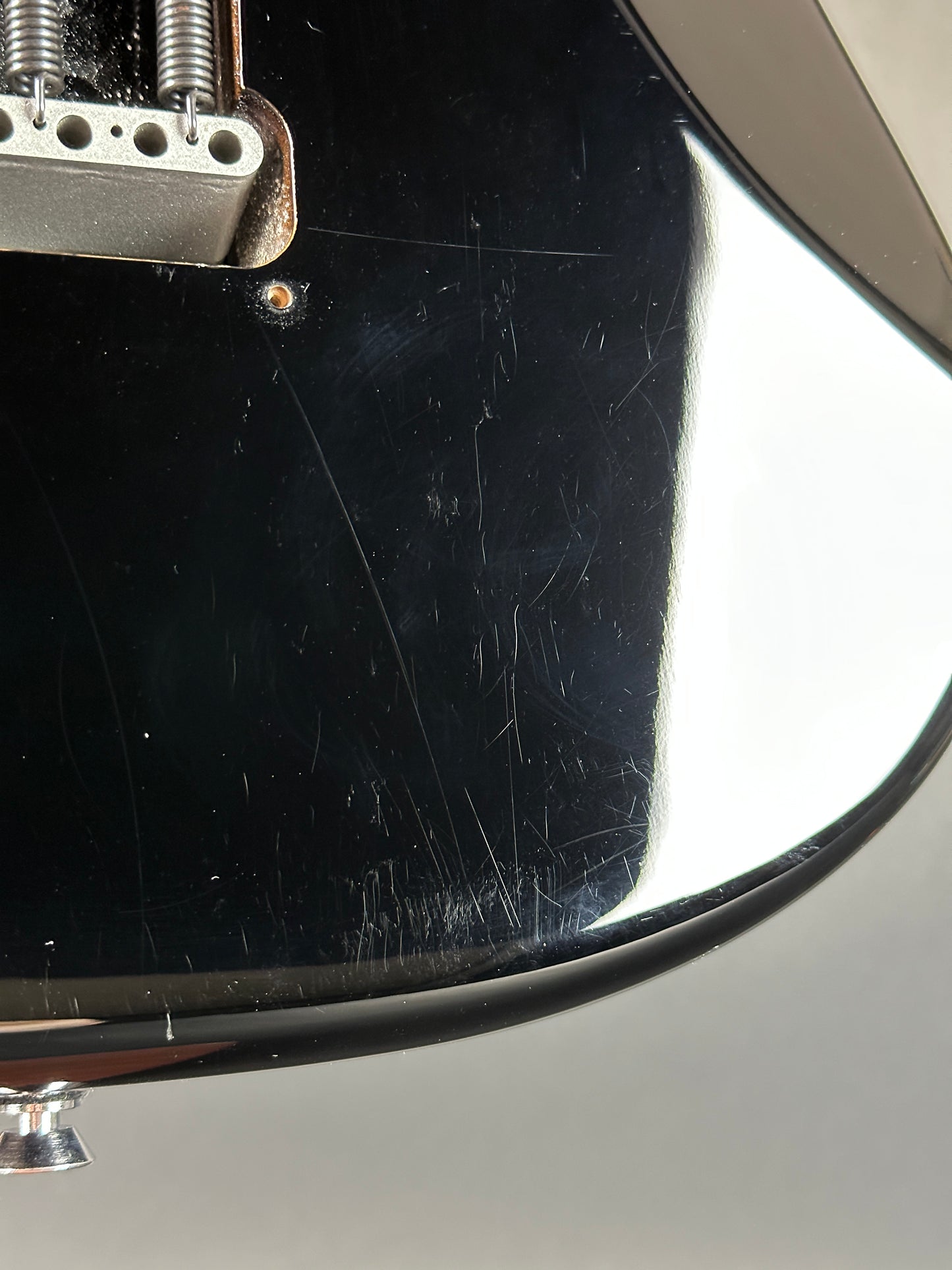 Scratches on back of Used 2013 Fender American Standard Strat Black.