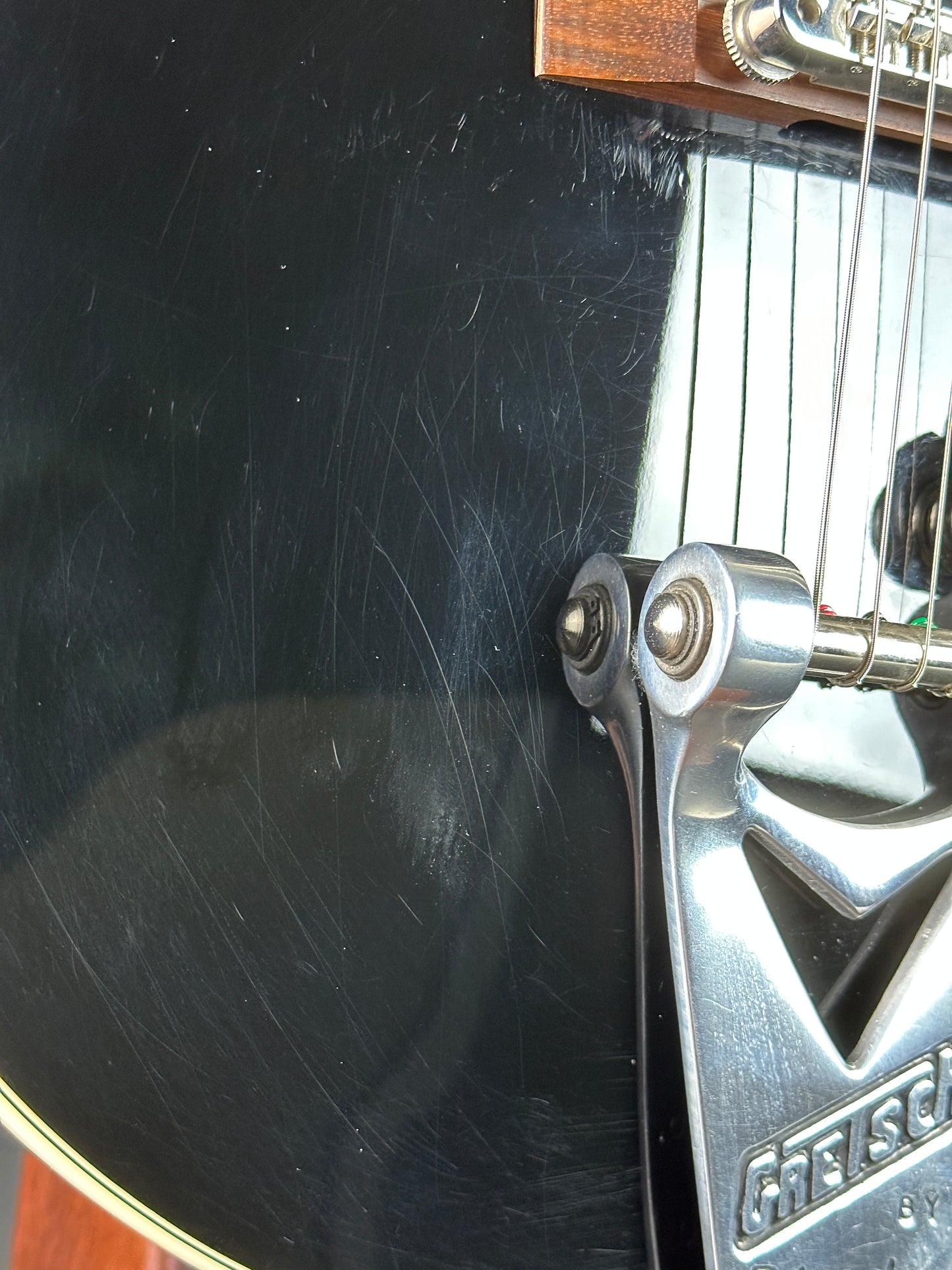 Scratches near tailpiece of Used Gretsch G6128T-TVP Power Jet.