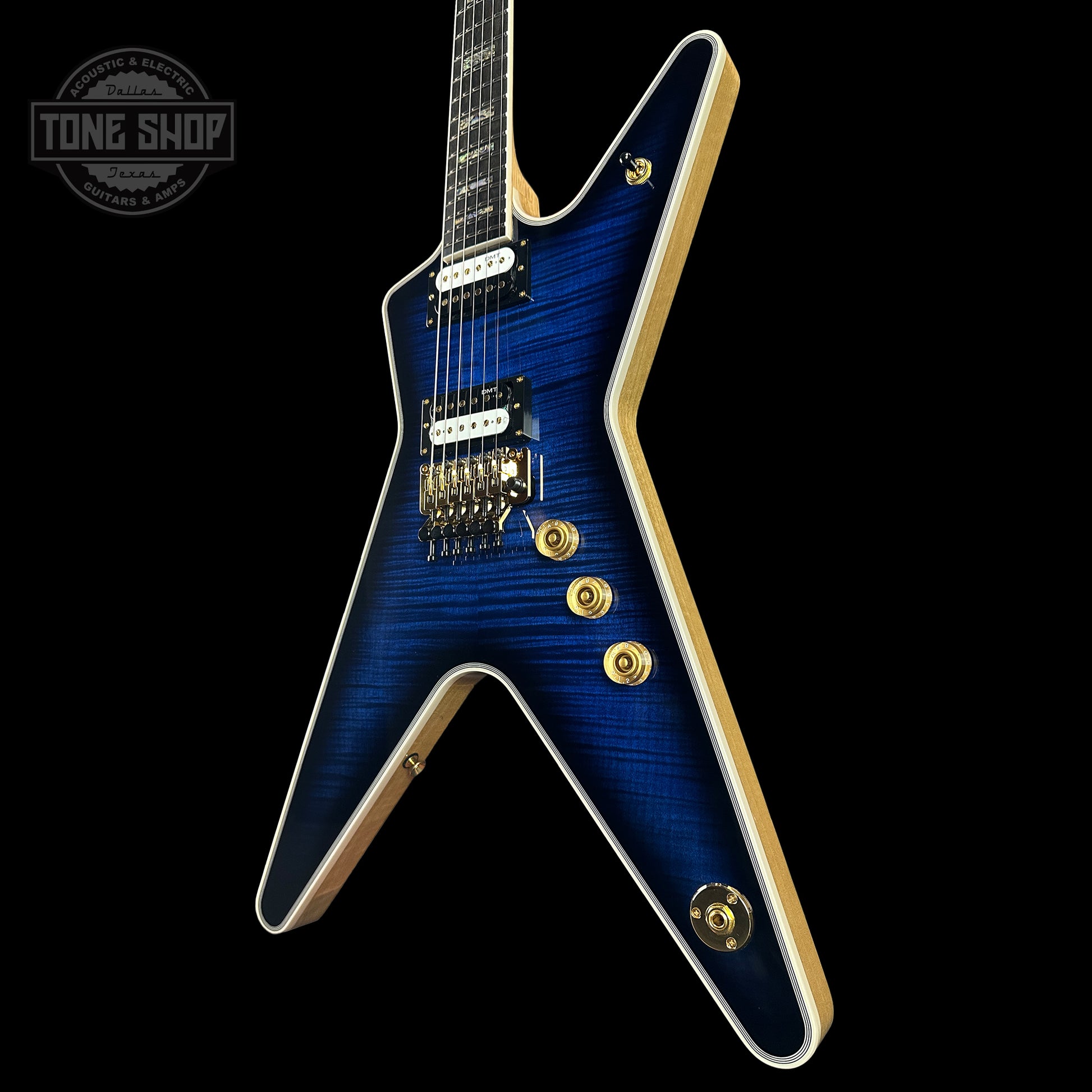 Front angle of Dean USA Custom Shop ML Trans Blue Flamed Maple Top Korina Body Gold Hardware.