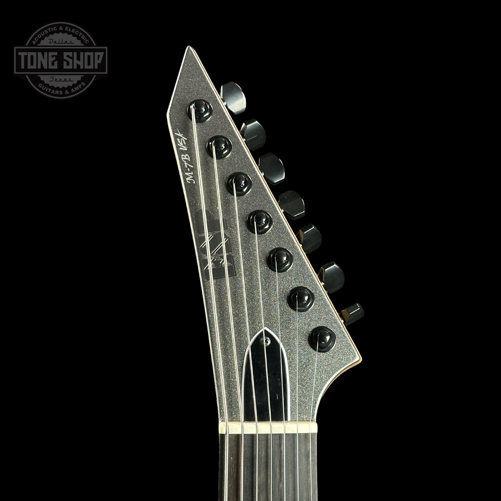 Front of headstock of ESP USA M-7 Baritone  Black Adamantium.