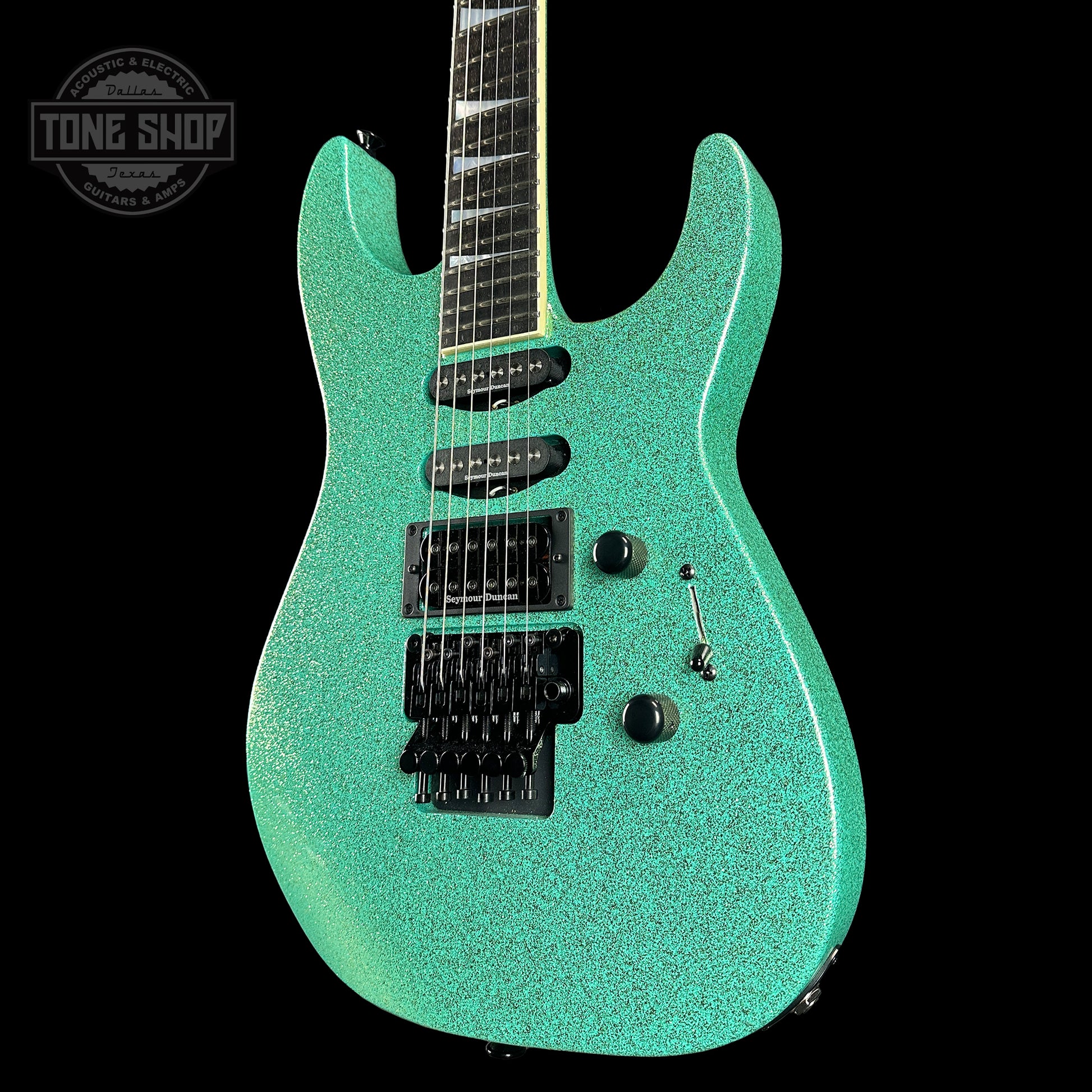 Front angle of Jackson Custom Shop SL1 Soloist RVRS FR Seafoam Sparkle.