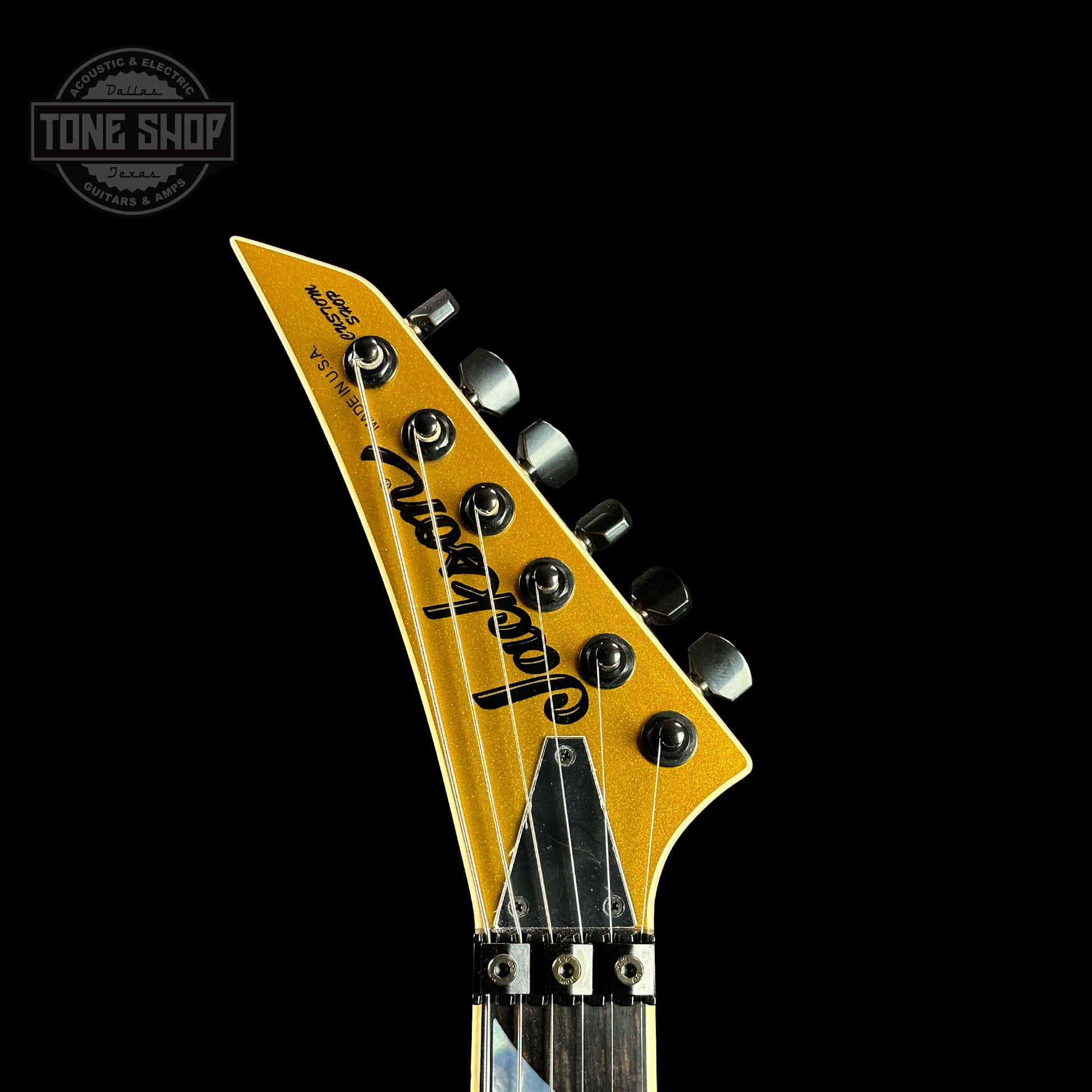 Front of headstock of Jackson Custom Shop SL2H Reverse Headstock Frost Gold.