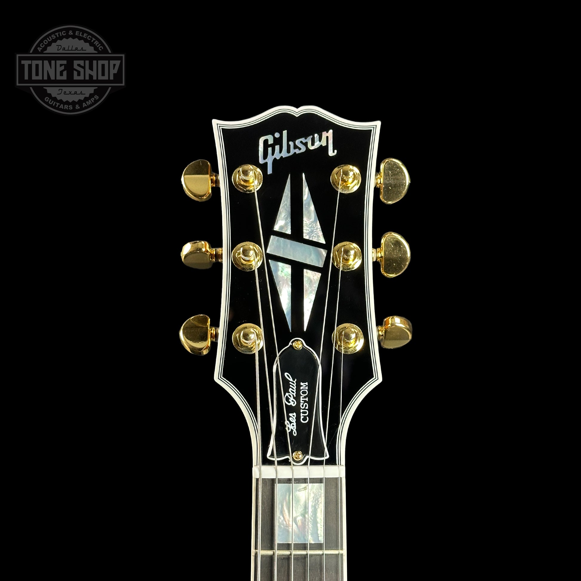 Front of headstock of Gibson Custom Shop Made 2 Measure Les Paul Custom Chambered Koa Gloss.