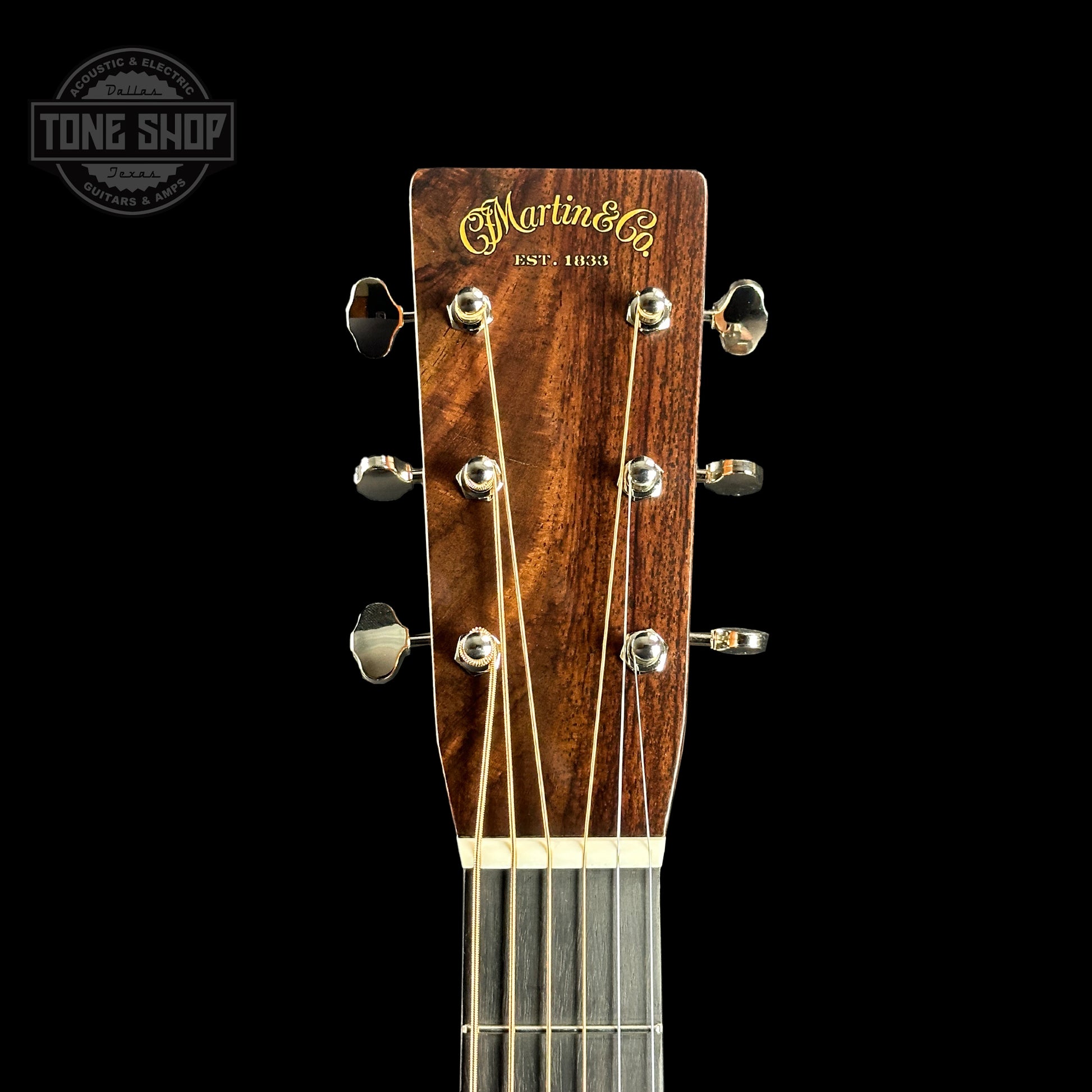 Front of headstock of Martin Custom Shop 28 Style Dread Adirondack/WEIR Ambertone.