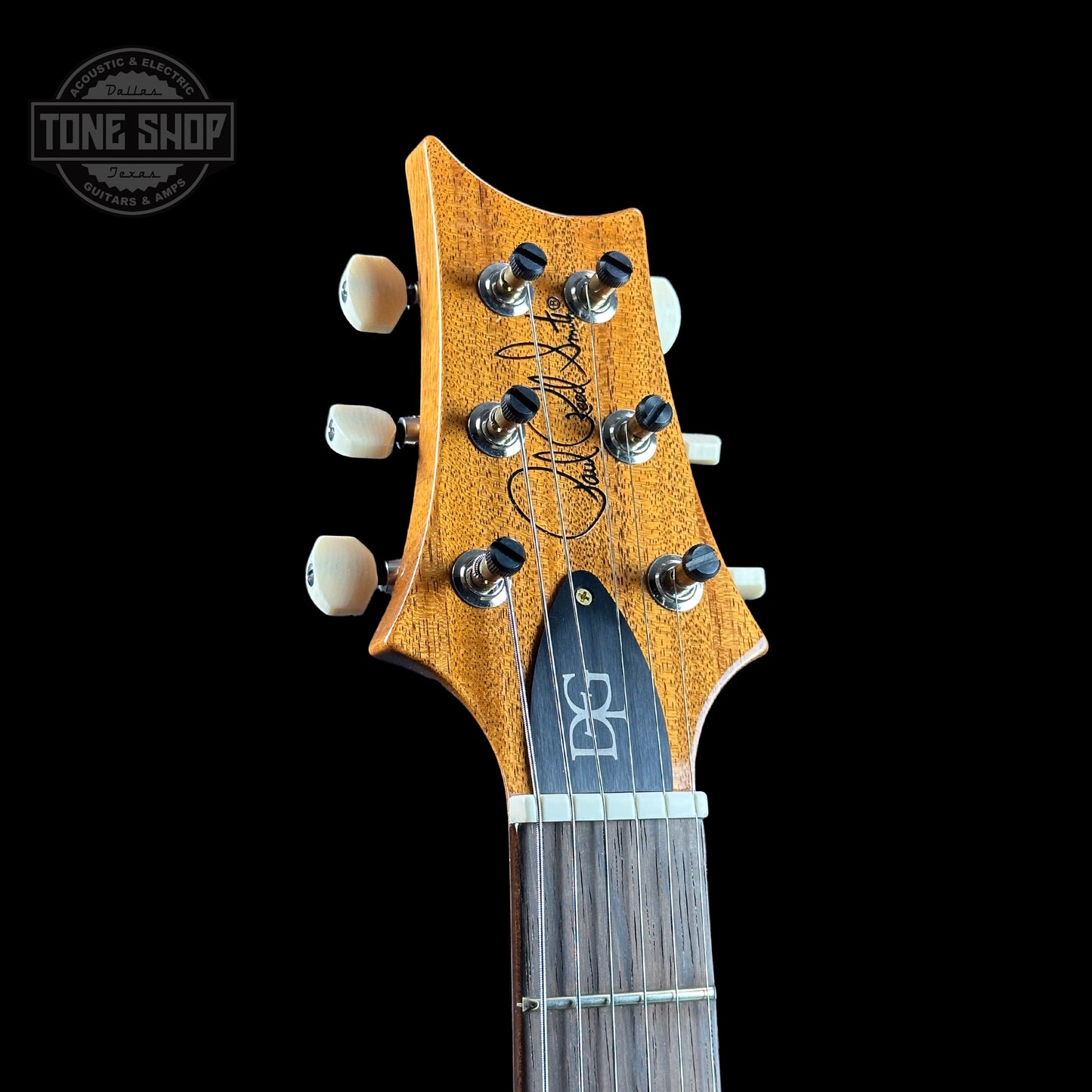 Front of headstock of PRS TSG Anniversary Wood Library Artist DGT Gold Storm Fade Brazilian Rosewood.